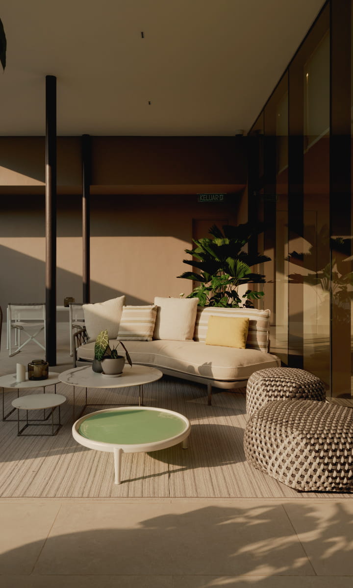 Sunlit outdoor lounge surrounded by greenery at Eden